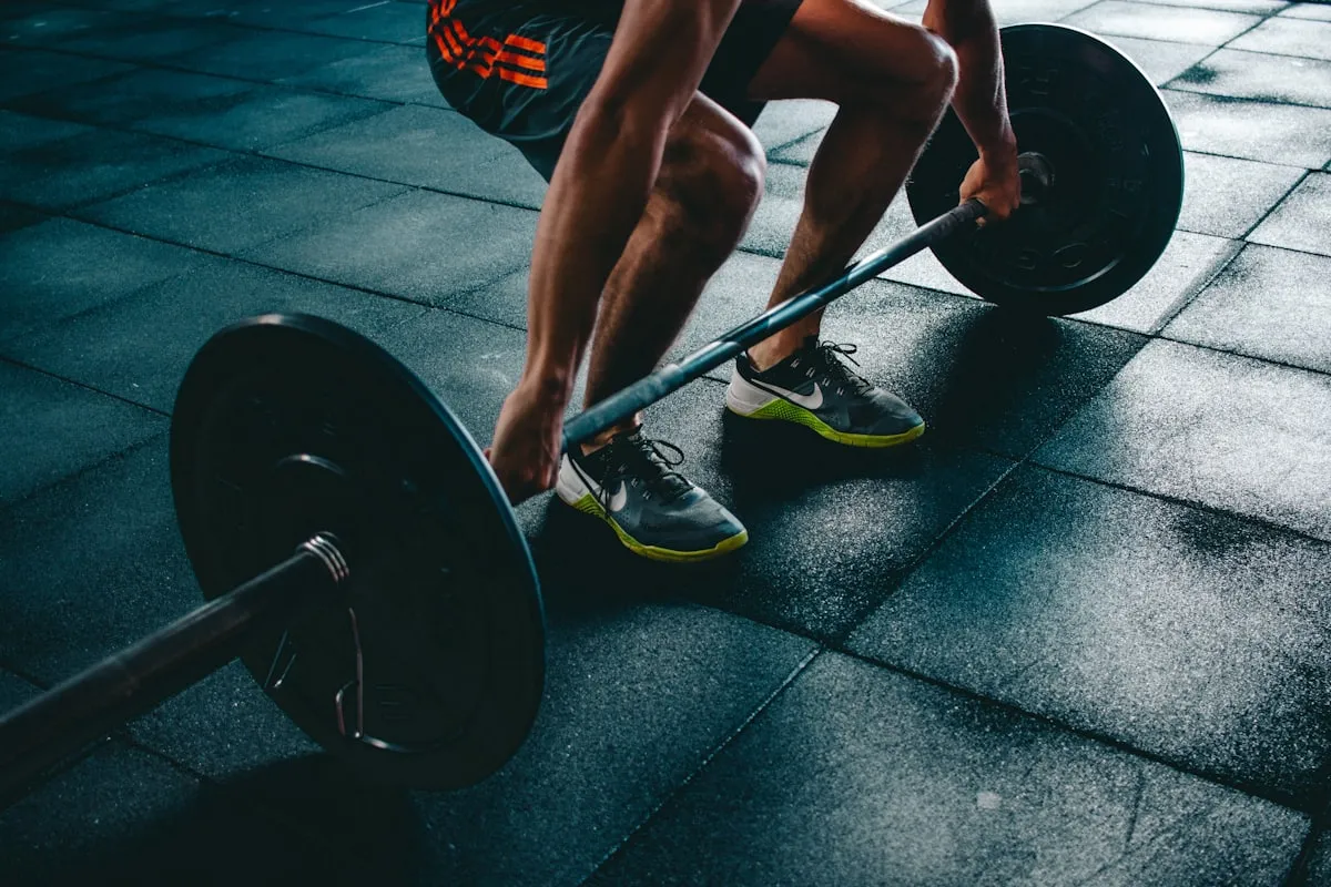 A person mid-deadlift in a gym